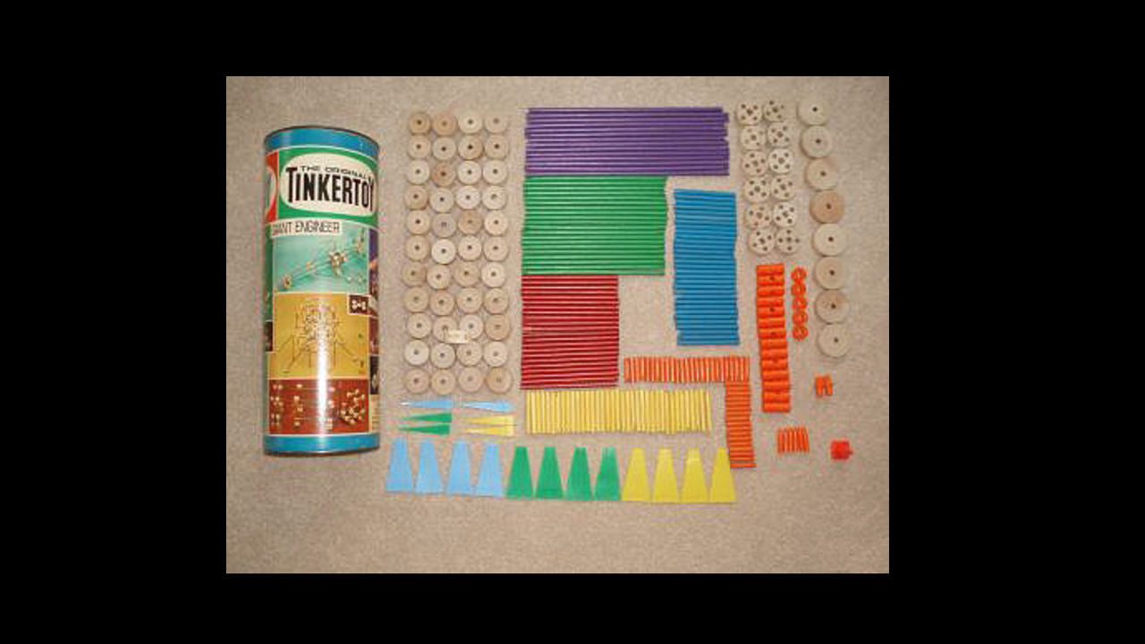 Vintage Tinker Toy set with multicolored rods and wooden connectors neatly organized next to cylindrical storage can