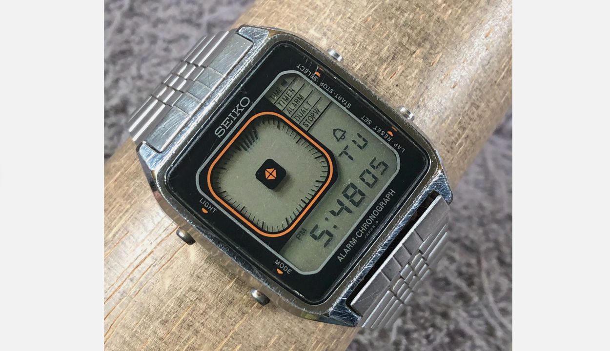 Close-up of a vintage Seiko digital wristwatch with a square face, metal band, and dual display layout