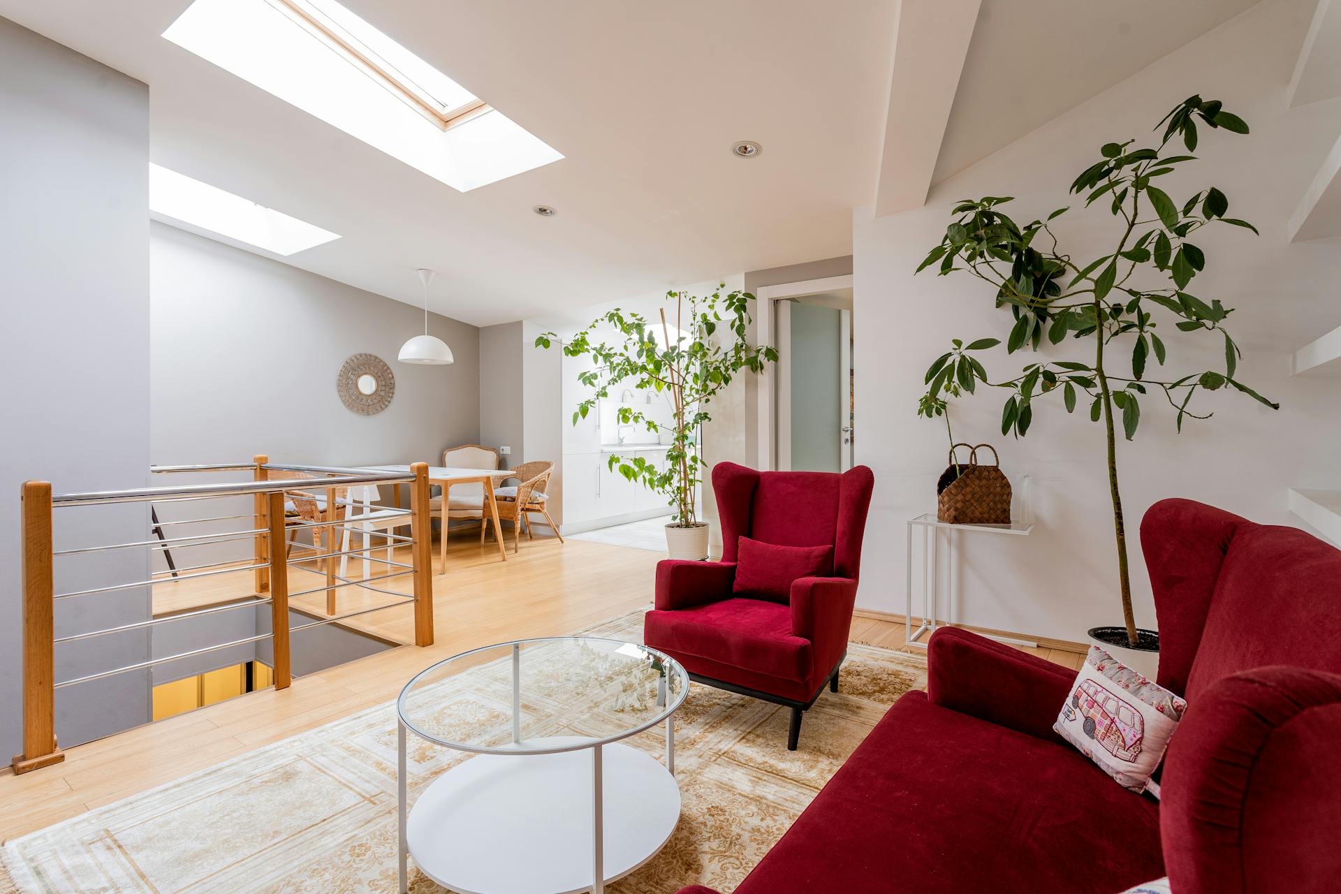 Interior of a Modern Living Room with a Red Sofa and Armchair skylight