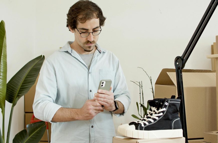 a man taking photo of item while declutter