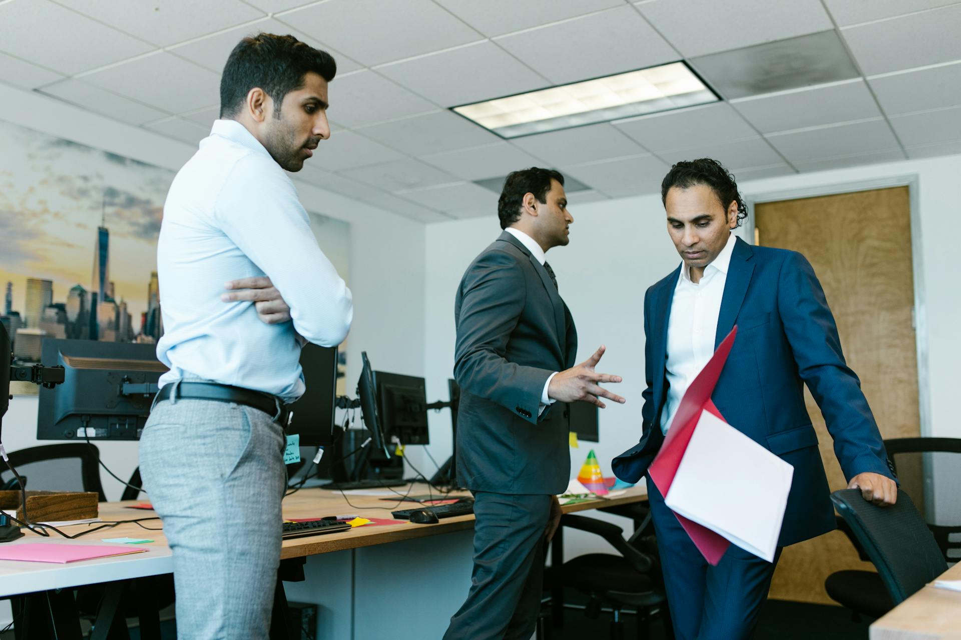 Man in Black Suit Throwing a Folder
