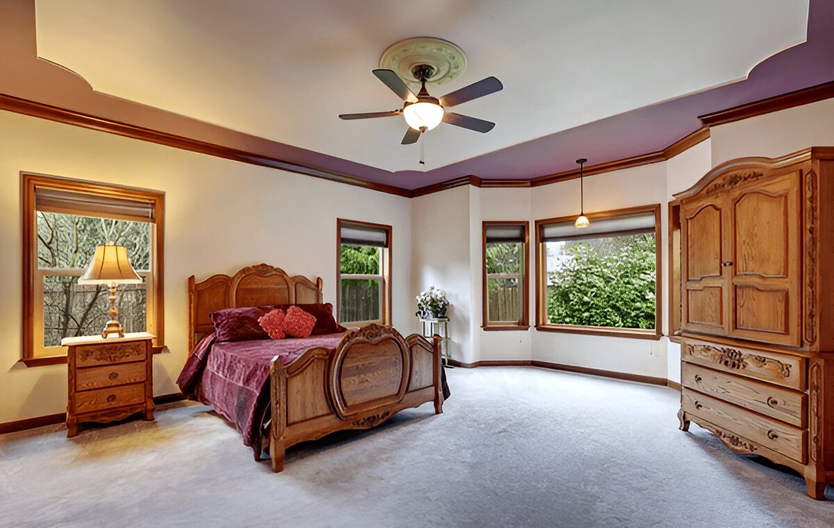 Master bedroom interior with antique hand carved solid wooden furniture set. Northwest, USA