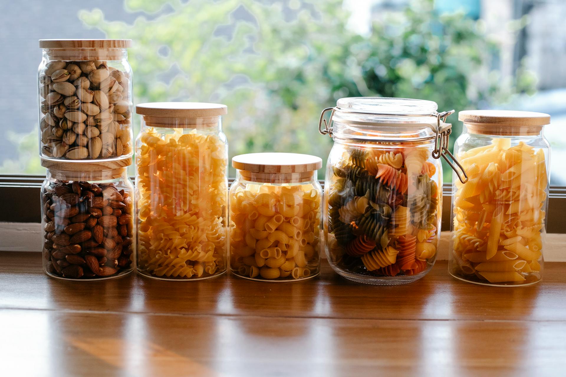 glass Jars with various raw pasta and nuts