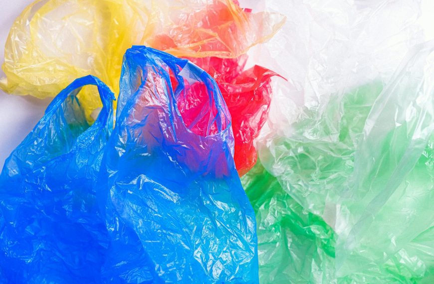 Clutter of plastic bags, crumpled and overlapping, various colors, translucent material, irregular shapes, scattered randomly