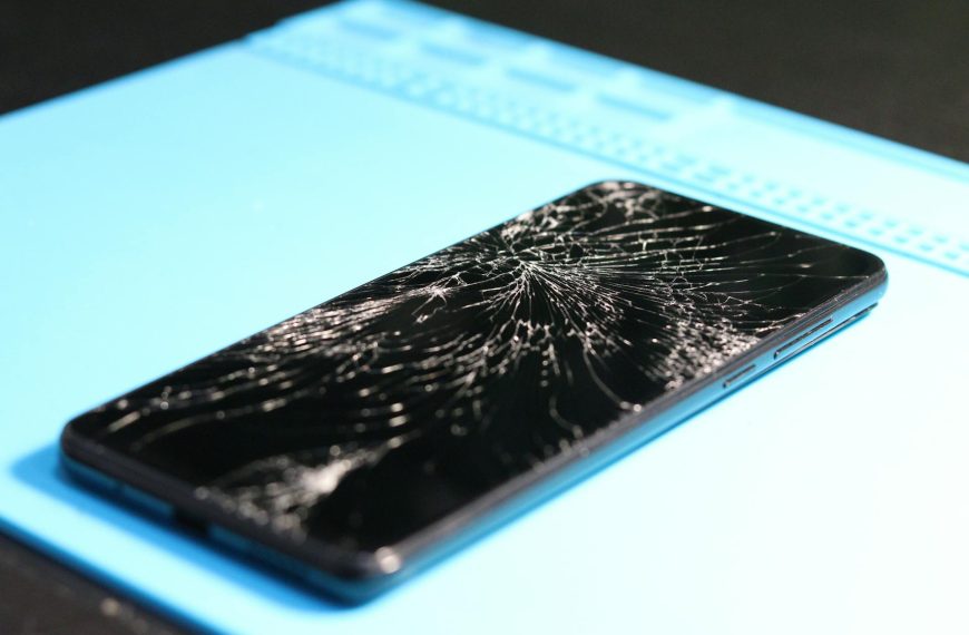 Close-up of a Broken Smartphone on Blue Background