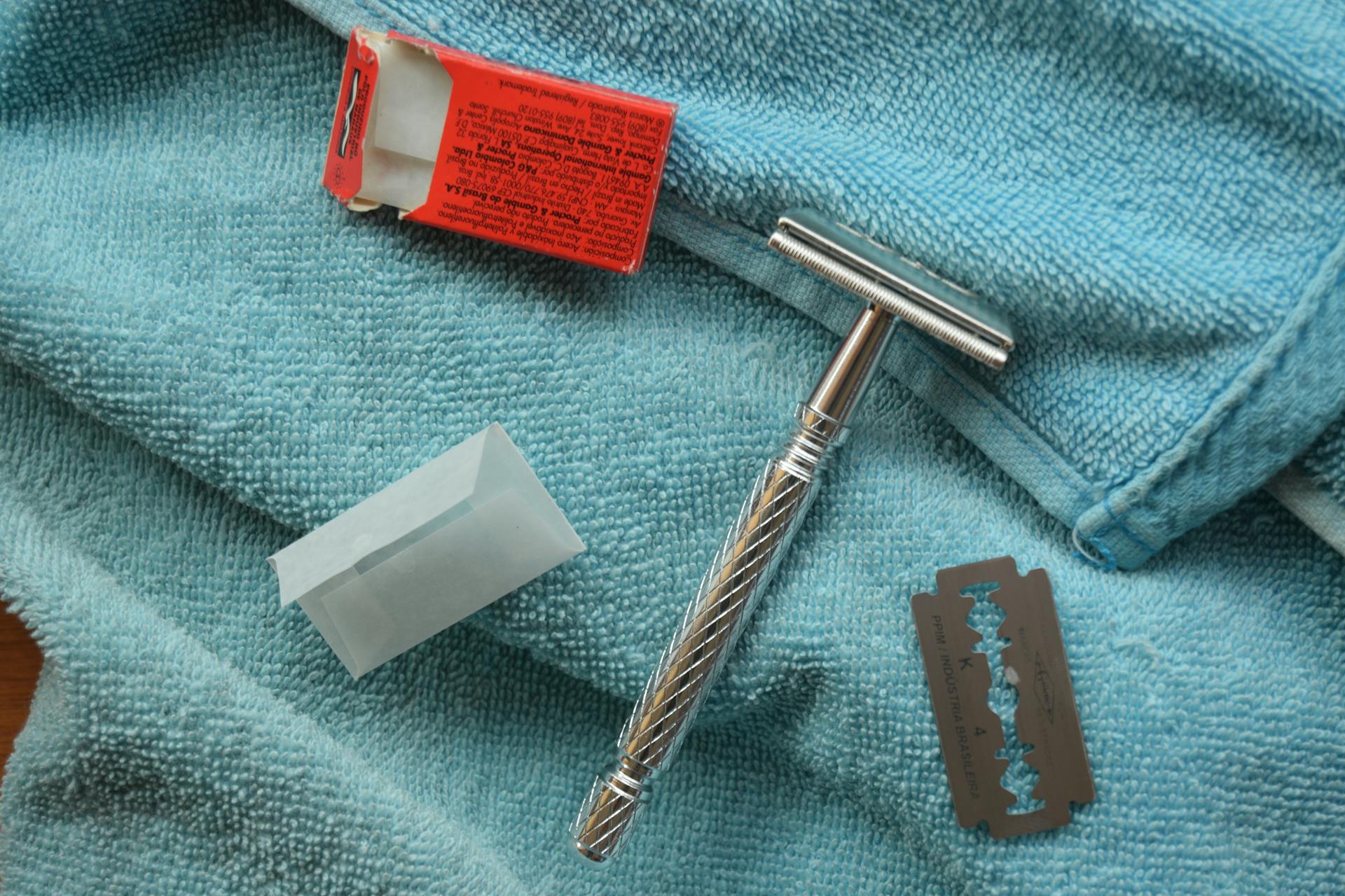 Silver safety Razor on Blue Bath Towel