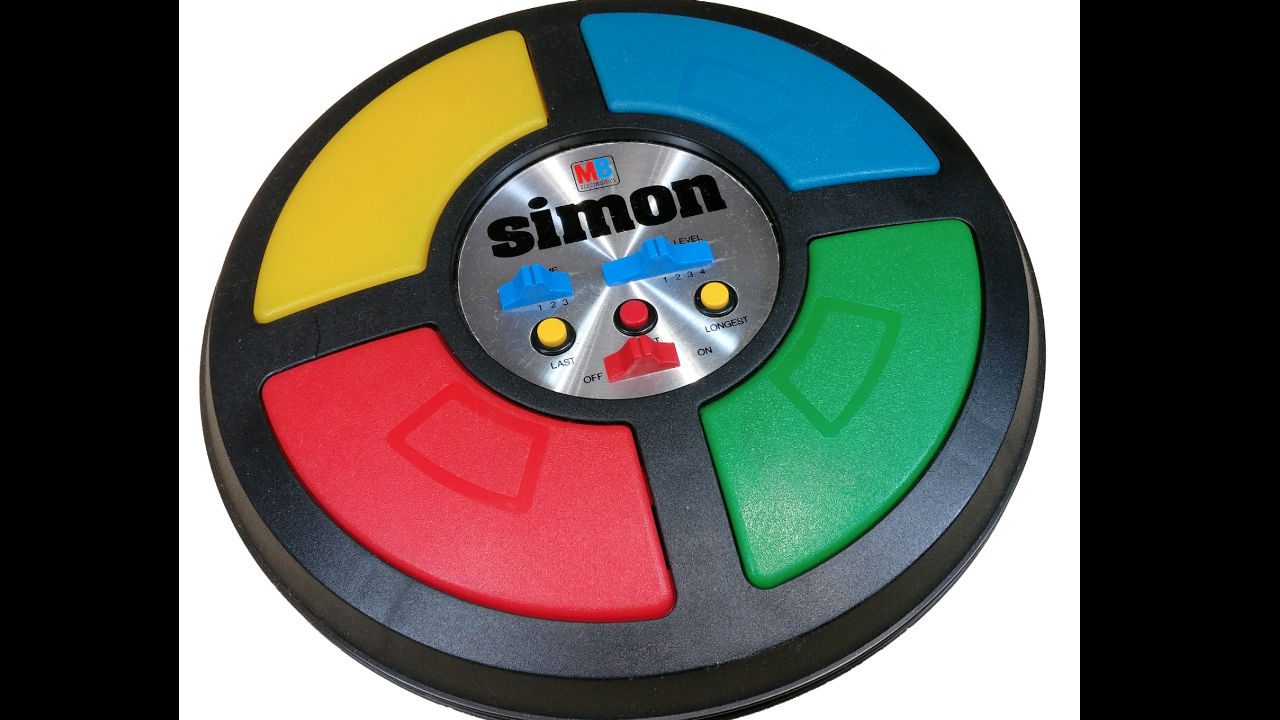 Close-up of a vintage Simon electronic memory game with red, yellow, green, and blue light-up buttons
