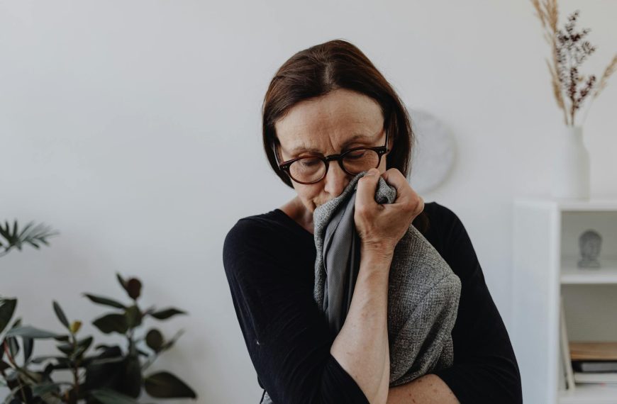 A Sad Woman in Black Top Holding a Gray Cloth