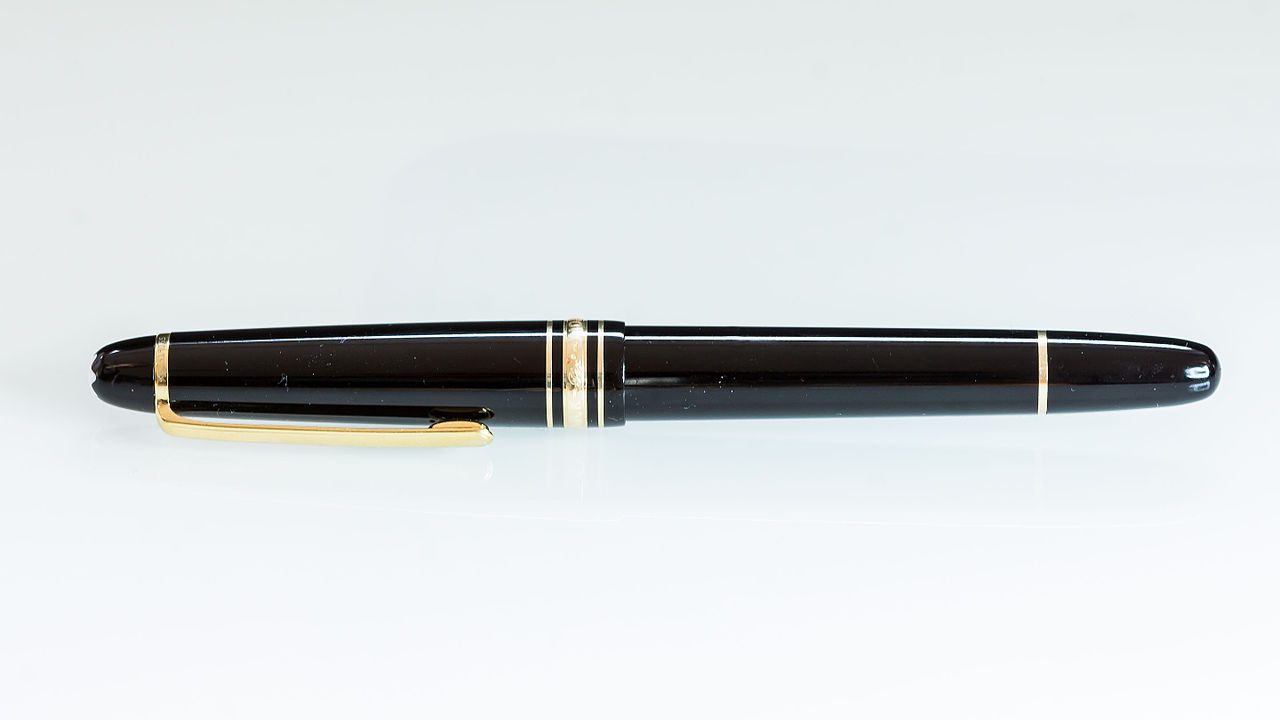 Black fountain pen, gold accents, closed cap, centered on white background, sleek and elegant design