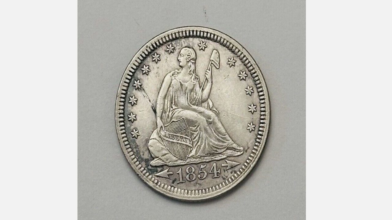1854 Seated Liberty Quarter, Liberty figure with shield and arrows, surrounded by stars, date at bottom