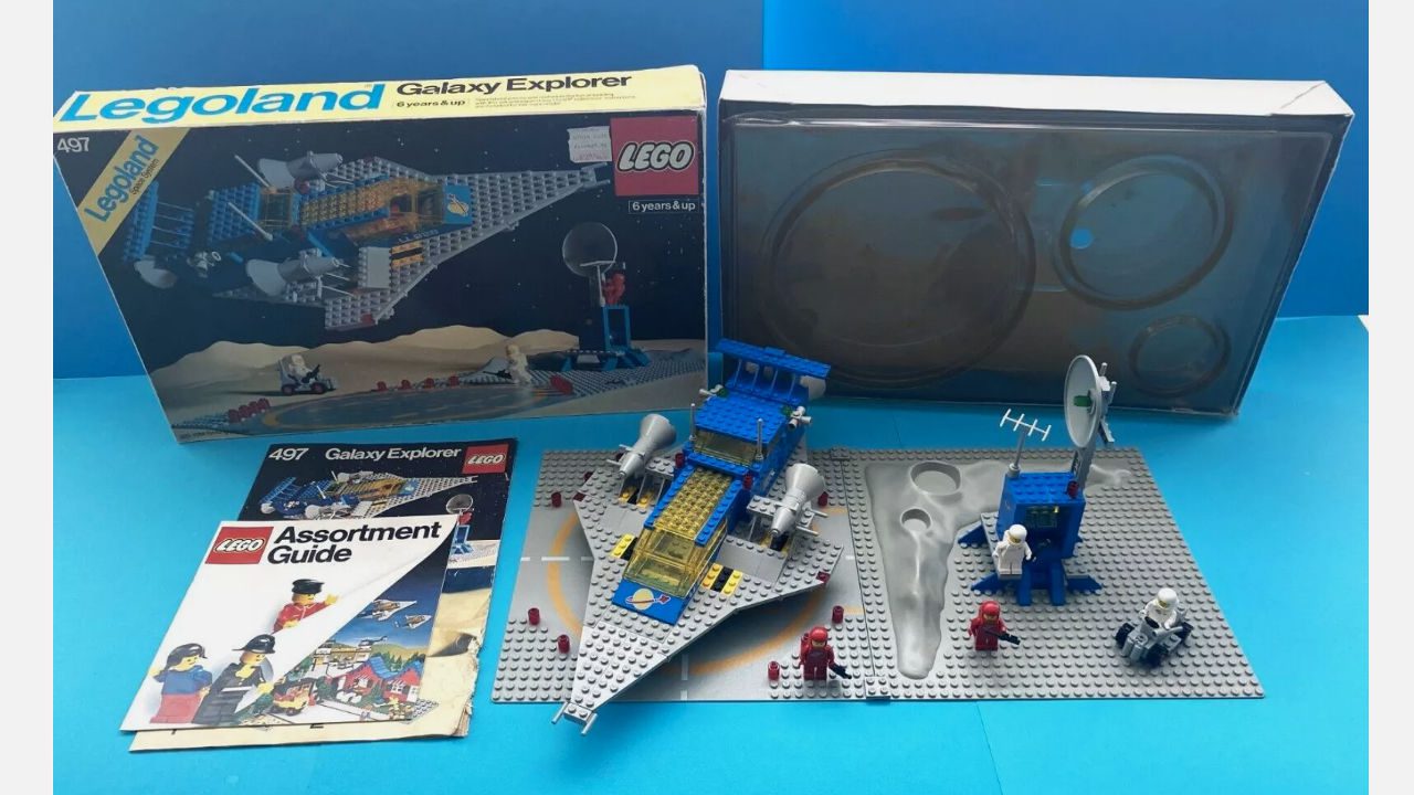 vintage 1980s LEGO Galaxy Explorer set with original box, manuals, space-themed baseplates, and assembled spacecraft