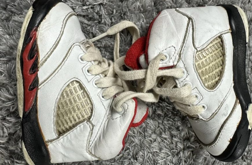 1980s Nike Air Jordan sneakers, high-top design, leather construction, bold color contrast, iconic Nike swoosh, visible Air sole unit, vintage basketball shoes