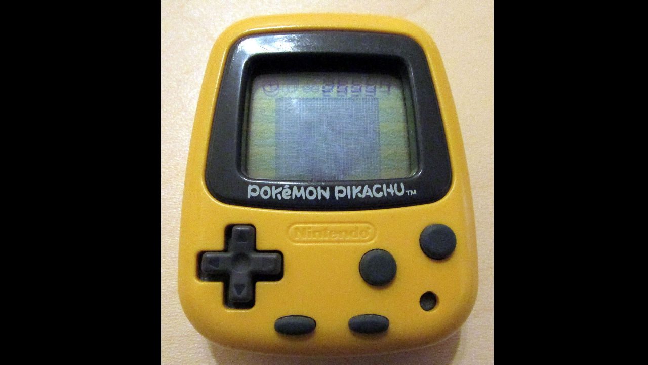 yellow Pokémon Pikachu handheld gaming device by Nintendo, with D-pad and three buttons, screen displaying faint image