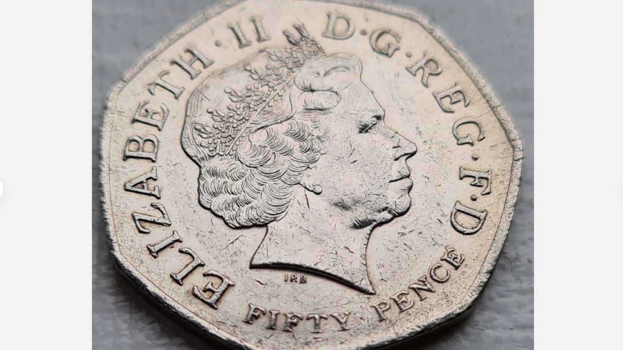 2009 British 50p coin featuring Queen Elizabeth II portrait, obverse side with detailed crown and lettering