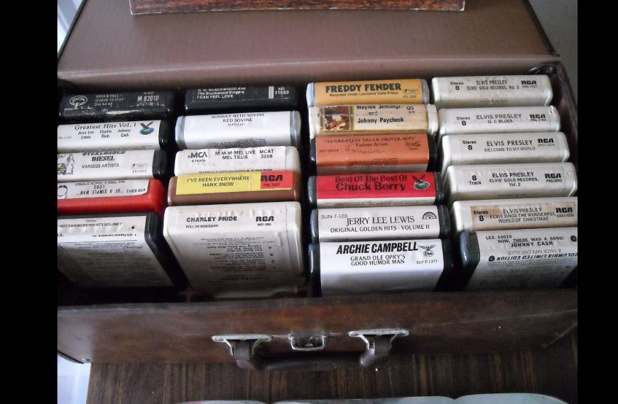 Box of vintage 8-track tapes neatly arranged, featuring artists like Elvis Presley, Johnny Cash, Chuck Berry, and Jerry Lee Lewis