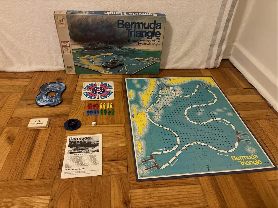 Bermuda Triangle board game, vintage game box, illustrated storm cloud and ships, colorful ocean-themed board, small plastic ship pieces, magnetic storm feature, 1970s design