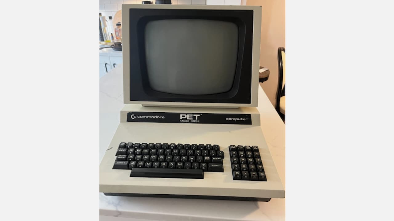Commodore PET computer, vintage personal computer, built-in monochrome monitor, attached keyboard, cassette tape drive, 1970s computing hardware, retro design