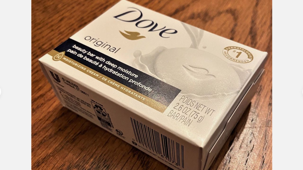 Dove Original Beauty Bar soap box, white packaging with gold and navy accents, placed on wooden surface