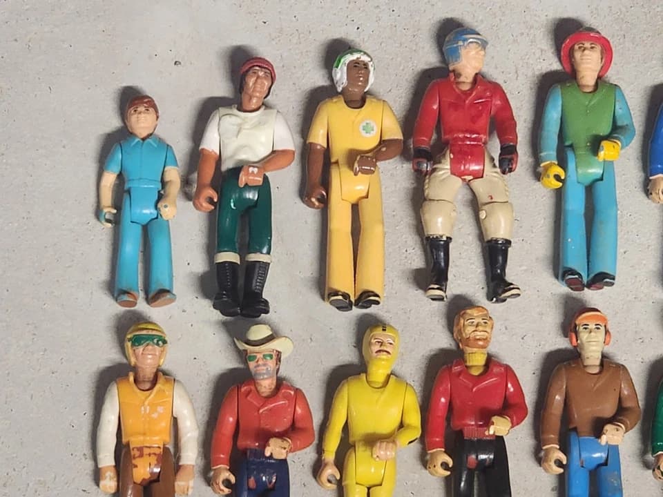 Fisher Price Adventure People figures, plastic action figures, colorful outfits, jointed arms and legs, vintage 1970s-1980s toys, small-scale, various professions represented, standing upright on display