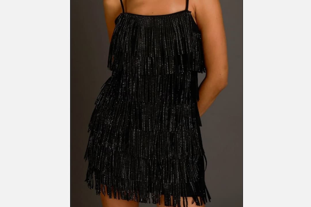 Fringe clothing, long hanging tassels, attached to hems or sleeves, suede or fabric material, boho or Western-inspired style, seen on jackets, skirts, or dresses, displayed on a mannequin or worn