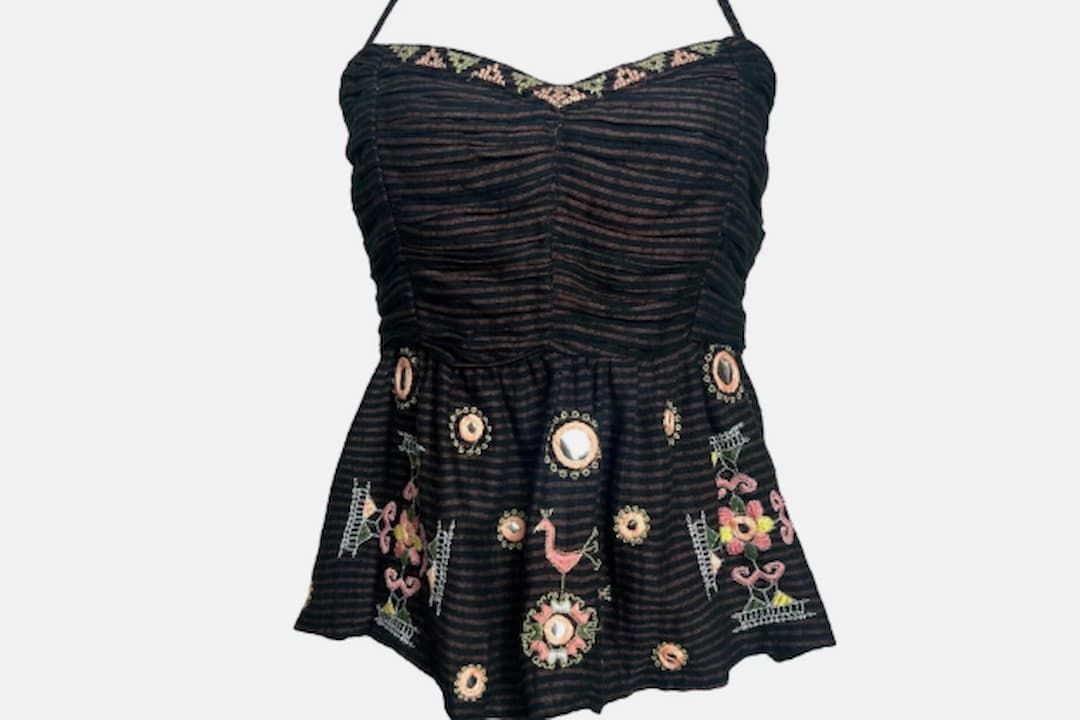 Halter top, sleeveless design, neckline tied or fastened behind the neck, open back, fitted or flowy style, lightweight fabric, often cropped, displayed on hanger or worn casually