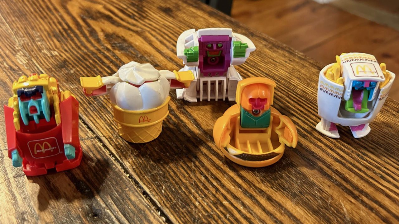 McDonald’s Happy Meal Changeables toys, robot transformers shaped like fries, burger, ice cream, drink, displayed on wooden table