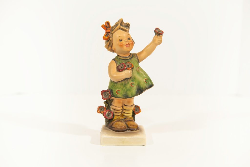 ceramic figurine of a girl holding a flower