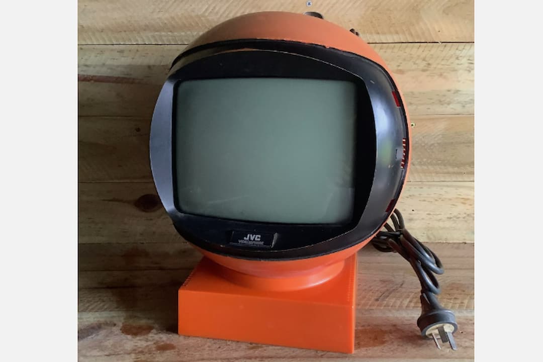 JVC Videosphere television, spherical retro TV, space-age design, white plastic casing, circular screen, built-in stand, 1970s vintage electronics