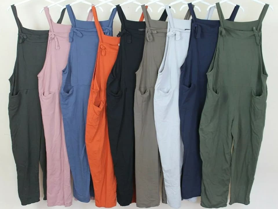 Jumpsuits, one-piece garment, fitted top and attached trousers, various fabrics and colors, sleeveless or long-sleeved styles, zipper or button closures, displayed on mannequins or worn casually or formally
