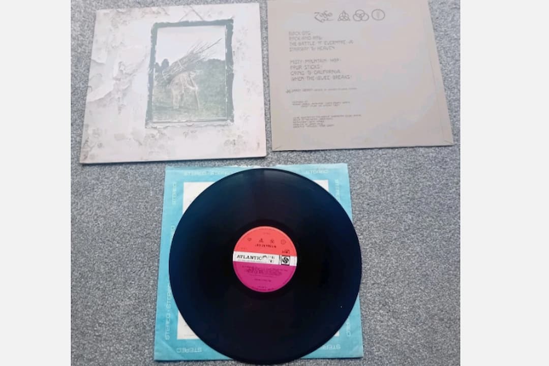 Led Zeppelin – Led Zeppelin IV album cover, aged wall background, framed painting of an old man carrying sticks on his back, rustic and textured design, no text or band name visible