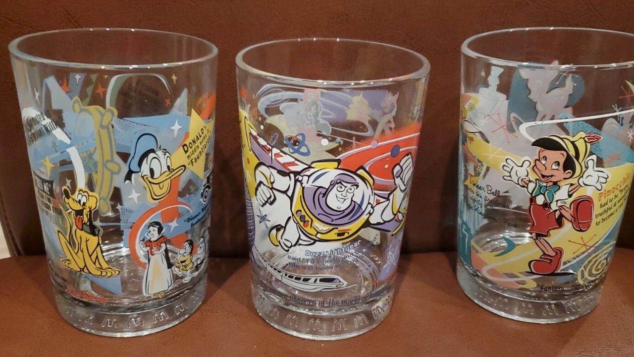 Three vintage McDonald’s Disney-themed glass cups featuring Donald Duck, Buzz Lightyear, and Pinocchio