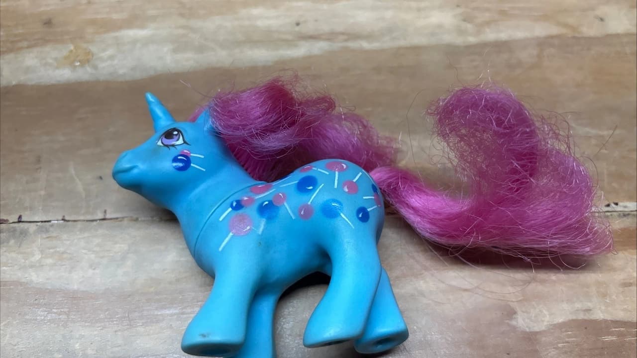 mail-order My Little Pony figures, colorful plastic ponies, unique hair colors, stamped symbols on flanks, vintage style, collectible packaging