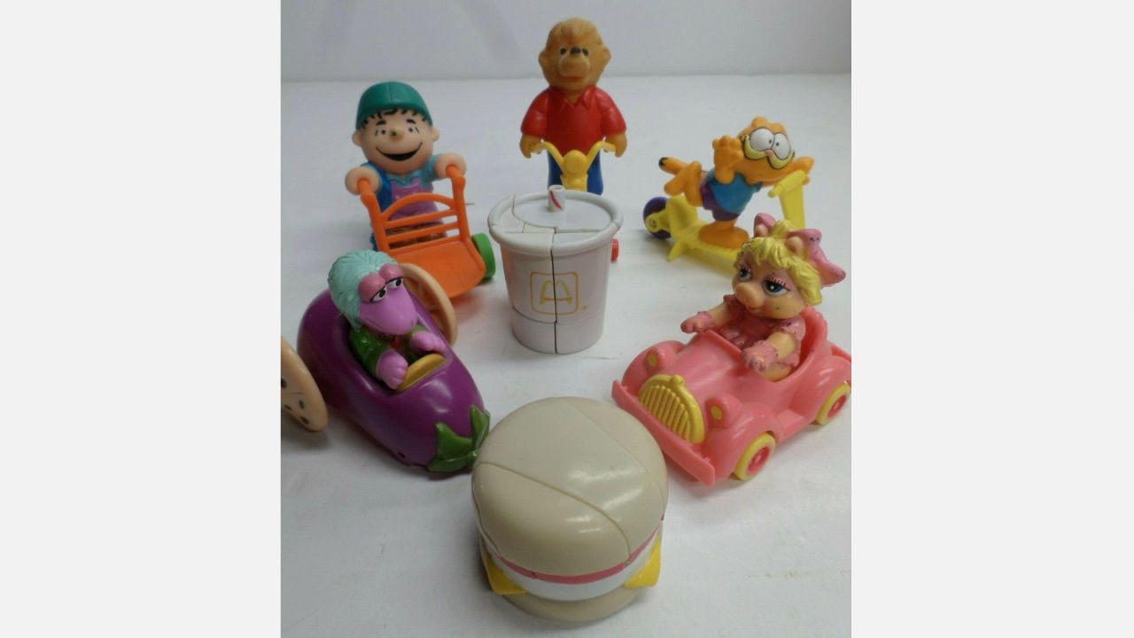Assorted vintage McDonald’s Happy Meal toys from the 1980s including Muppet Babies, food characters, and McDonaldland figures