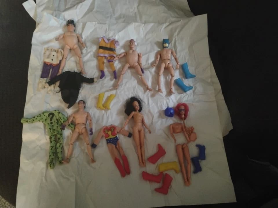 Mego Superheroes action figures, vintage 8-inch dolls, cloth costumes, plastic molded heads, iconic comic book characters, bright colors, articulated limbs, standing in a row