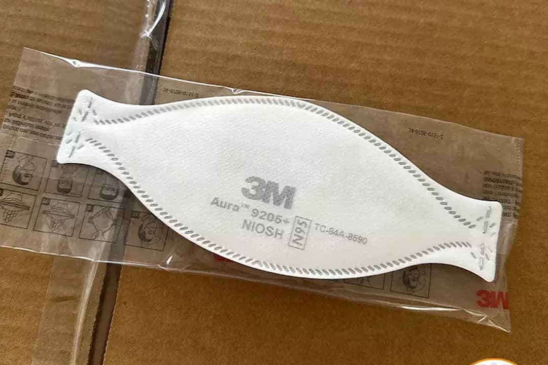 N95 face masks, white protective respirators, cup-shaped design, adjustable nose clip, elastic ear loops, medical-grade material, labeled front