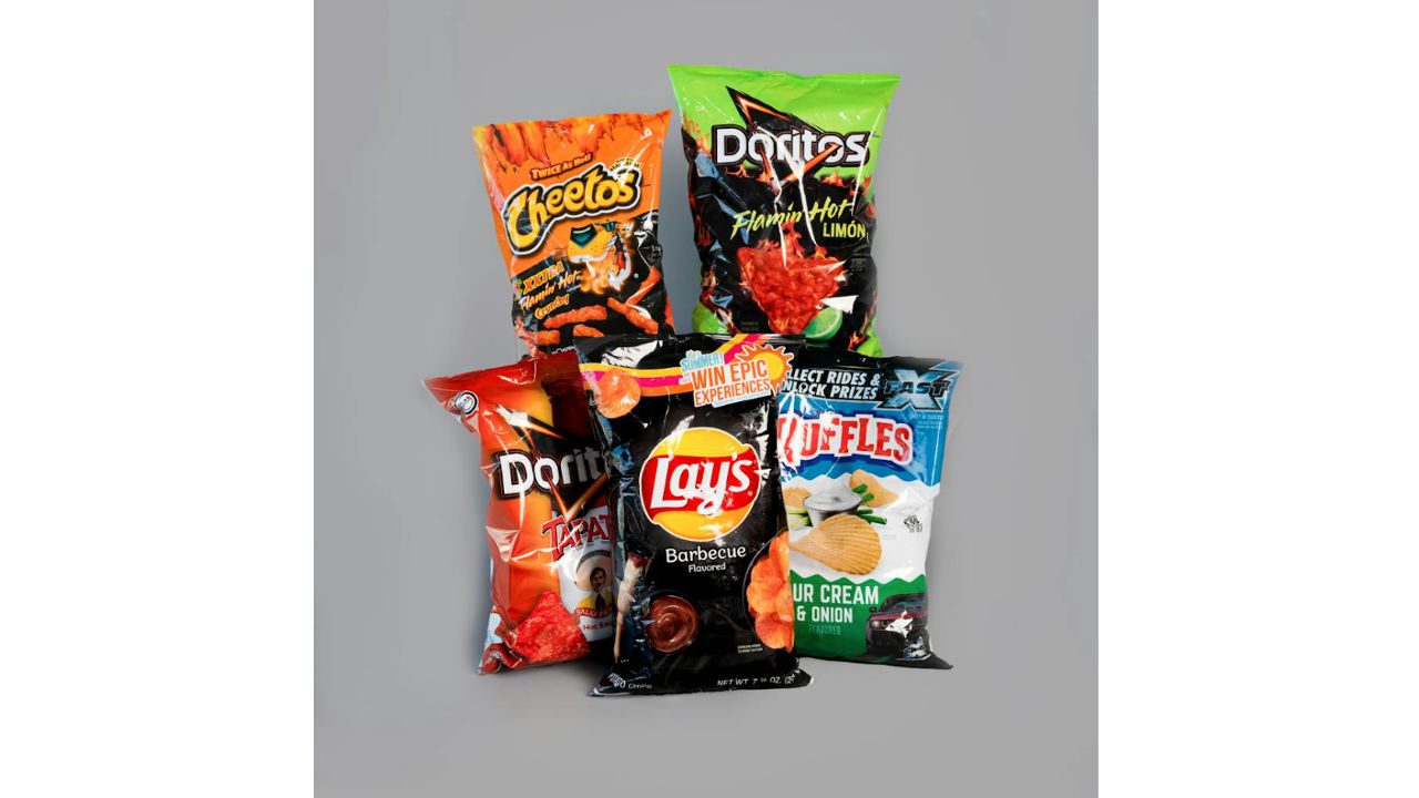 Assorted bags of name-brand chips, including Cheetos, Doritos, Lays, and Ruffles, arranged on gray background