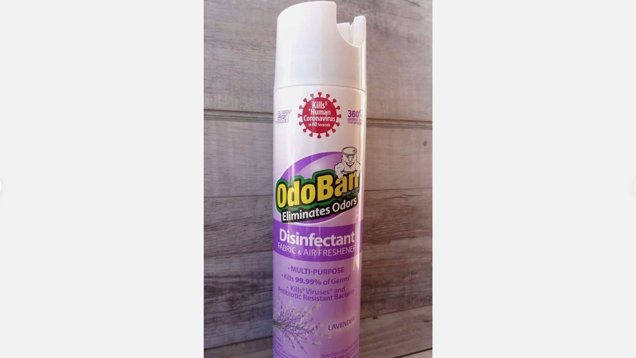 OdoBan lavender disinfectant spray can placed against a wooden background