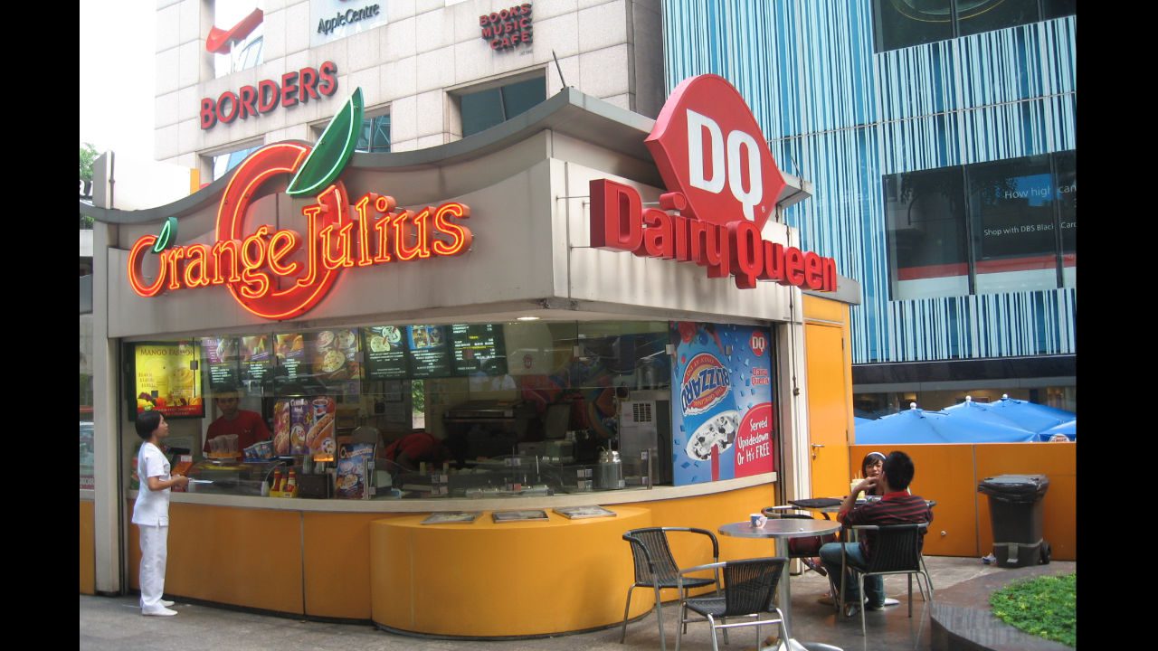 Orange Julius and Dairy Queen kiosk with outdoor seating and people ordering food