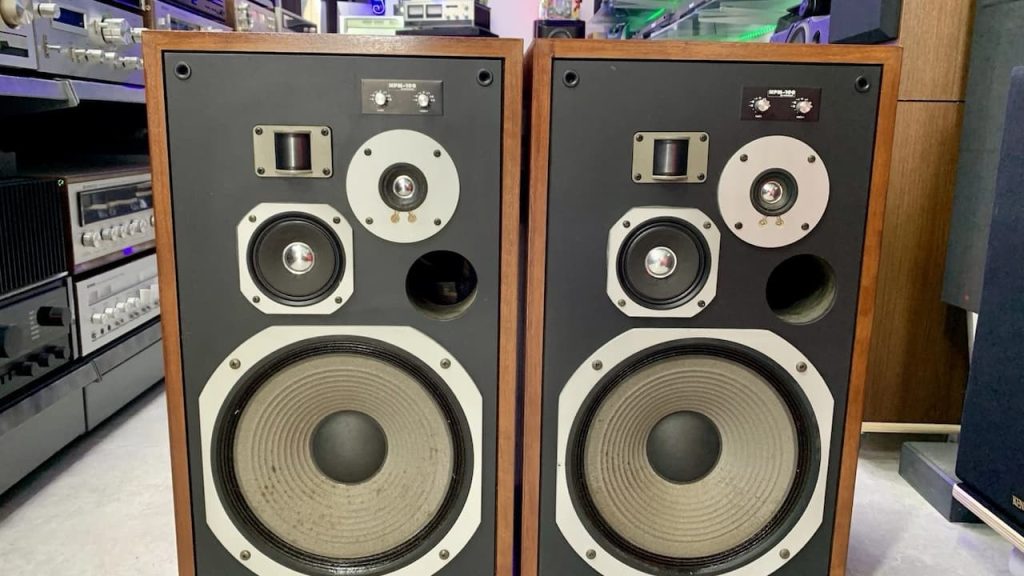 Pioneer HPM-100 speakers, vintage wooden speaker cabinets, black front panel, large woofers, midrange and tweeter drivers, silver trim rings, exposed audio drivers, retro audio equipment