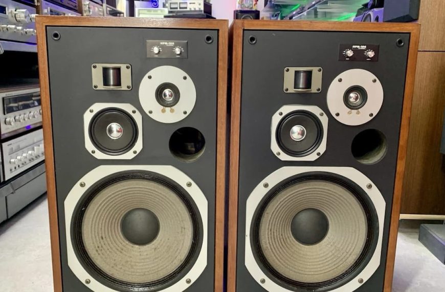 Pioneer HPM-100 speakers, vintage wooden speaker cabinets, black front panel, large woofers, midrange and tweeter drivers, silver trim rings, exposed audio drivers, retro audio equipment