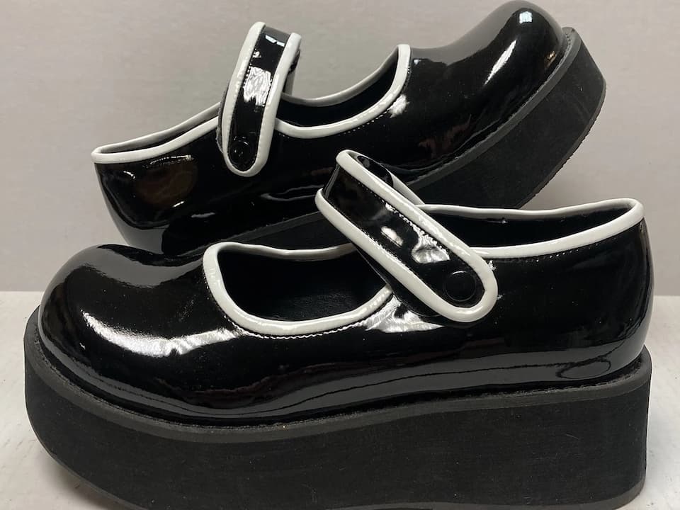 Platform shoes, high thick soles, chunky heels, glossy finish, bold color design, retro 1970s style, ankle strap or slip-on design, displayed on a clean surface