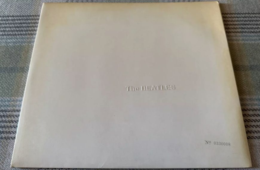 Rare edition of The Beatles' self-titled "White Album" with embossed band name and unique serial number No. 0330008 on a minimalist white cover