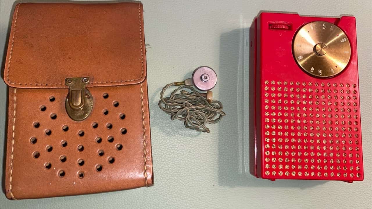 Regency TR-1 transistor radio, compact rectangular body, perforated front speaker grill, analog tuning dial, vintage 1950s design, early portable radio.