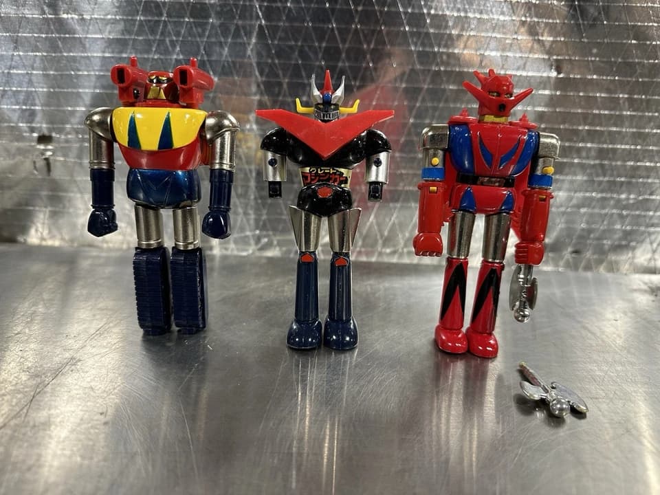 Shogun Warriors action figure, vintage Japanese robot toy, brightly colored plastic, spring-loaded weapons, articulated limbs, 1970s-1980s design, standing upright