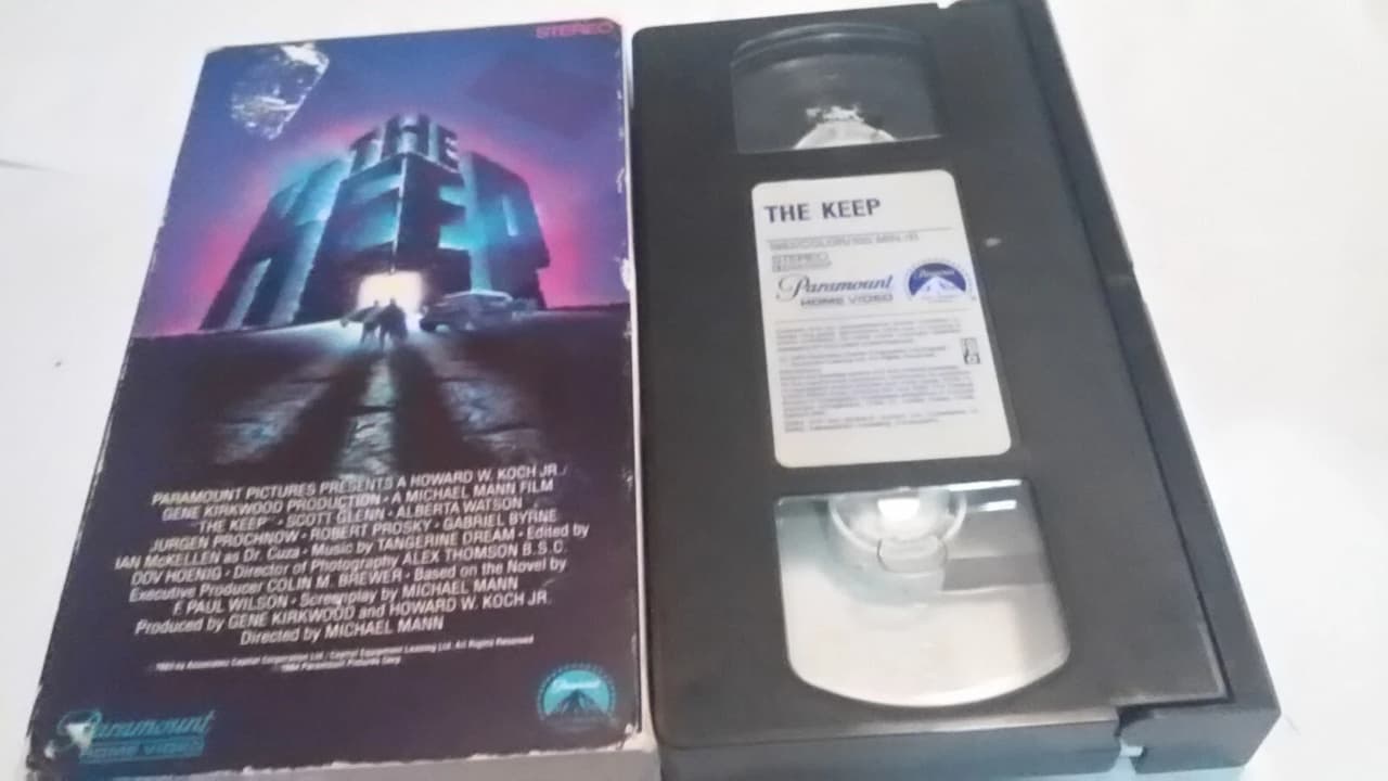 VHS tape and cover of the film “The Keep” by Paramount Home Video, cover art shows a glowing fortress with silhouetted figures, VHS label marked with film title and production details