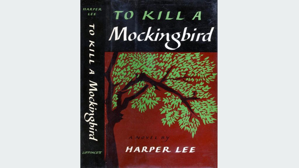 Dust jacket of the book "To Kill a Mockingbird" by Harper Lee, black background with green tree branches and leaves, red ground below the tree, white and green title text, author’s name in bold white on red at the bottom, spine features title and author vertically