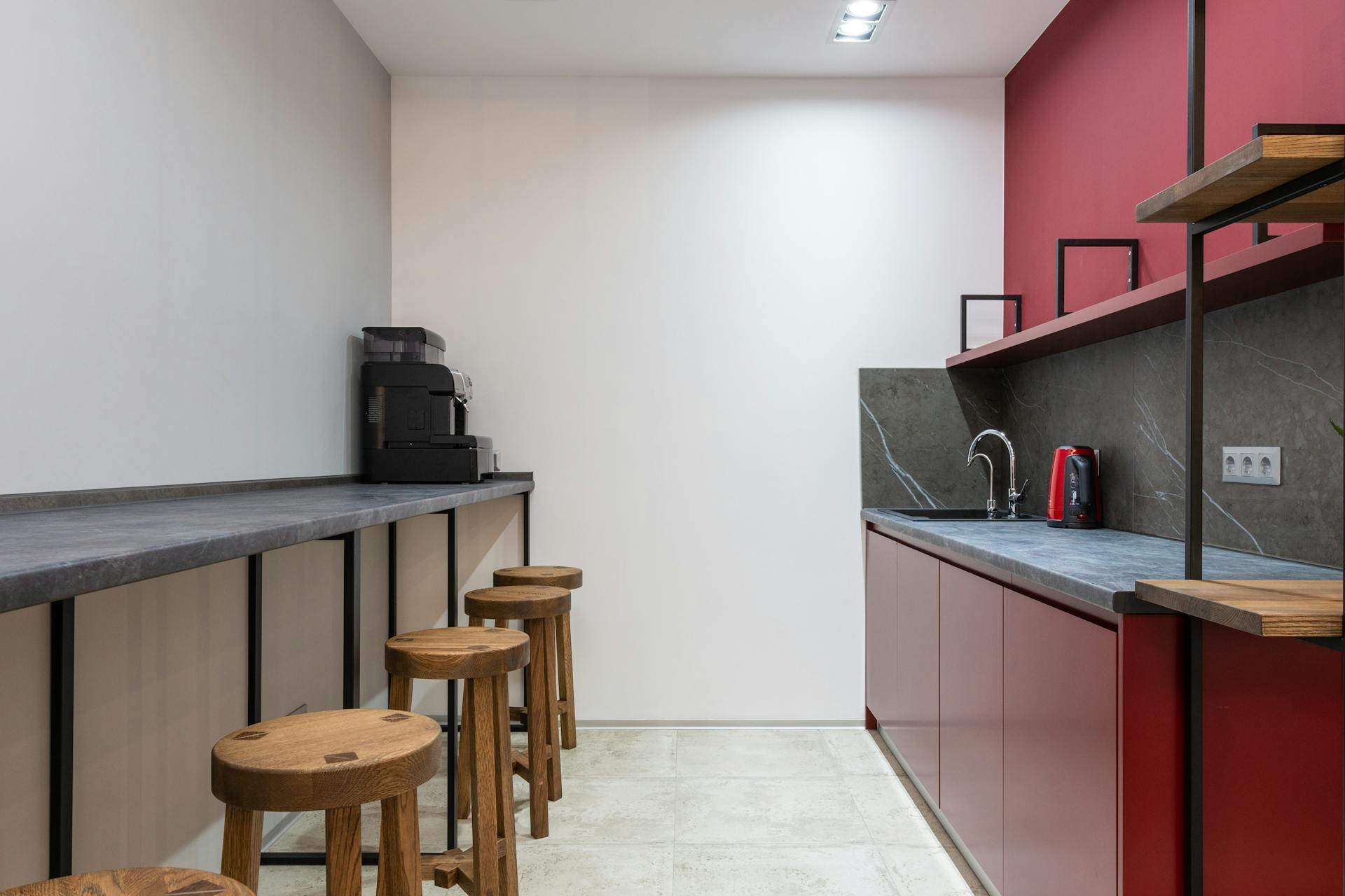 Office with counter and chairs near open kitchen