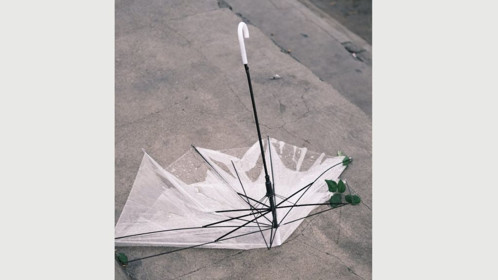 broken umbrellas, Broken clear umbrella flipped inside out on a concrete ground