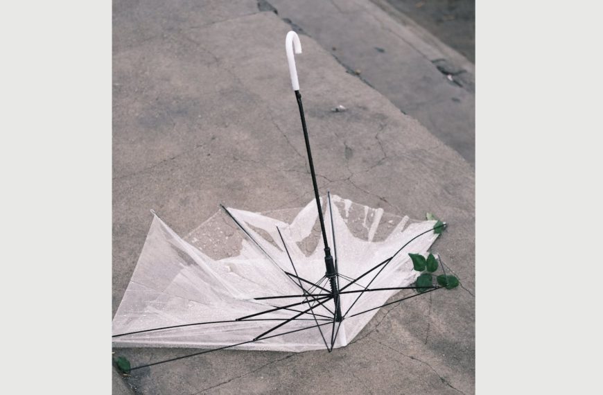 broken umbrellas, Broken clear umbrella flipped inside out on a concrete ground