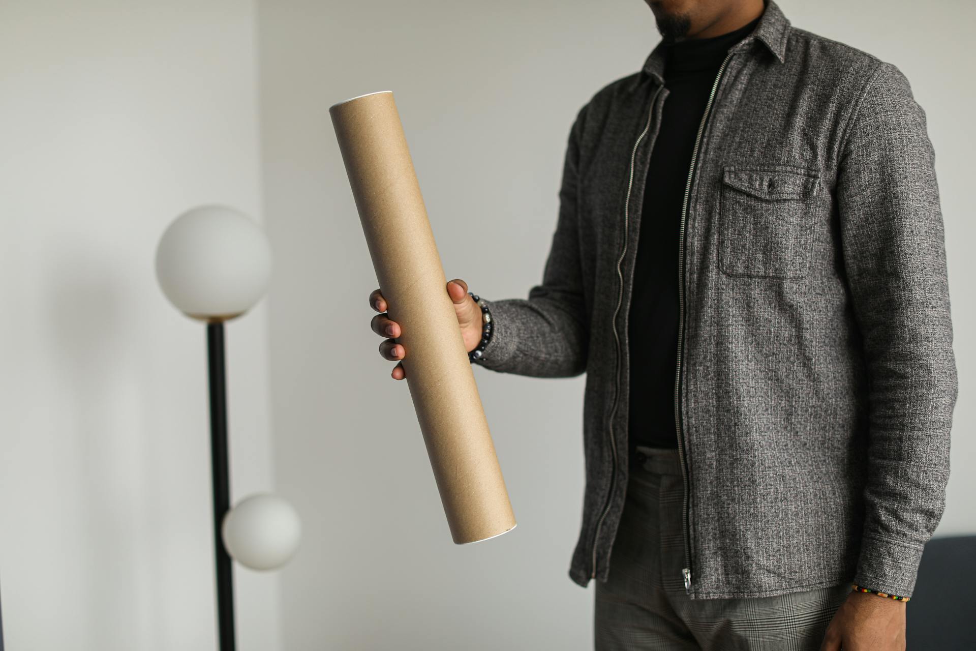 A Person Holding a Cardboard Tube